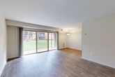 Located at 28 Fort Evans Rd NE in Leesburg, Virginia, this 2-bedroom, 1-bathroom single-floor residence offers a practical and comfortable layout. The open living and dining area is a standout feature, showcasing warm hardwood-style flooring, crisp white walls, and a wall of sliding glass doors that flood the space with natural light and provide direct access to a private patio overlooking a green lawn. A pendant light fixture anchors the dining area, adding a subtle decorative touch.

The kitchen is well-appointed with warm wood cabinetry, granite-style countertops, stainless steel appliances including a gas range, microwave, and dishwasher, and a convenient pantry for additional storage. Hardwood-style flooring continues throughout the main living areas, creating a cohesive aesthetic.

The spacious primary bedroom features plush carpeting, dual closets offering generous storage, and a window that brings in natural light. A walk-in closet provides additional organization space. The second bedroom also features soft carpeting and a clean, neutral palette.

The bathroom is finished with neutral large-format tile surrounds a full soaking tub and shower combination, complemented by a white vanity. A utility room and multiple closets throughout round out the functional offerings of this well-organized Leesburg residence.