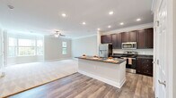 Located at 520 Meadow Branch Ave in Winchester, VA, this single-floor, one-bedroom, one-bathroom unit offers a comfortable and efficiently designed living space. The open-concept layout connects the kitchen and living room seamlessly, creating a sense of spaciousness throughout the main living area.

The kitchen is a standout feature, showcasing rich dark-wood cabinetry extending to the ceiling, dark granite countertops, and a full suite of stainless steel appliances, including a refrigerator, range, and microwave. A peninsula with matching granite provides additional prep space and casual seating. Wood-look flooring runs throughout the kitchen and entry areas, adding warmth and durability.

The living room is generously sized, featuring plush carpet, crown molding, a ceiling fan, and windows that allow natural light to fill the space. The bedroom is well-proportioned, offering carpeted flooring, a ceiling fan, and a large window with views of surrounding greenery. Some configurations also feature a charming bay window.

The bathroom includes a tiled walk-in shower with a glass door, granite vanity, and tile flooring, completing this clean and cohesive unit.