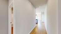 Located at 5033 Old Middleton Rd in Madison, WI, this thoughtfully designed 2-bedroom, 1-bathroom residence offers a clean, modern aesthetic throughout its single-floor layout. The open kitchen and living area serves as the heart of the home, showcasing white shaker cabinetry, granite countertops, stainless steel appliances, and light hardwood-style flooring. A sliding glass door connects the kitchen directly to a private balcony, where a railing-enclosed outdoor space offers elevated views of lush surrounding trees and the Madison skyline. The primary bedroom is a generously sized retreat featuring plush carpeting, multiple windows that invite abundant natural light, and a ceiling fan for year-round comfort. The second bedroom also offers hardwood-style flooring and a large window with pleasant outdoor views. The bathroom is clean and functional, complete with a full soaking tub and shower combination alongside warm-toned flooring. A dedicated laundry area houses a stacked washer and dryer unit alongside a Carrier HVAC system, ensuring convenience and efficient climate control. Neutral tones and consistent finishes throughout create a cohesive and inviting atmosphere across the entire residence.
