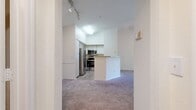 This 640 square foot apartment in Orlando, Florida offers a thoughtful layout that maximizes space and functionality. The single-story unit features one bedroom and two bathrooms, providing comfort and convenience. The modern kitchen is equipped with stainless steel appliances, including a built-in microwave and oven, and white cabinetry for ample storage. Light-toned wood-look flooring in the kitchen transitions to plush carpeting in the living areas and bedroom, creating a cozy atmosphere.

The spacious living room boasts high ceilings with a decorative fan, enhancing the sense of openness. Large windows allow natural light to flood the space, offering pleasant views of the surrounding greenery. The bedroom, measuring 140 square feet, also features a ceiling fan and a generous window, ensuring a bright and airy feel.

Both bathrooms are well-appointed, with one featuring a vanity with under-sink storage and a large mirror. The other bathroom includes a full-sized bathtub with a shower, ideal for relaxation. The unit also benefits from an in-unit laundry room with full-sized washer and dryer, adding to the overall convenience of the space.

The apartment's efficient design incorporates a closet for additional storage, making the most of the available square footage. Overall, this compact yet well-designed apartment offers a comfortable living space with modern amenities in a desirable Orlando location.