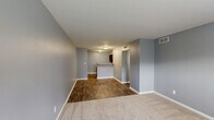 Located at 1012 33rd St SW in Birmingham, Alabama, this single-story 2-bedroom, 1-bathroom home offers a practical and cohesive layout designed for comfortable everyday living. Throughout the home, cool gray walls and crisp white trim create a clean, neutral palette that lends a consistent aesthetic to each room.

The combined kitchen and living area serves as the heart of the home, featuring wood-look flooring that extends through the main spaces. The kitchen is equipped with dark cabinetry, light countertops, a double-basin sink, and black appliances including a range and refrigerator, providing ample storage and functionality.

The living area transitions smoothly from the kitchen, with a mix of hard flooring and carpeted zones that define the space. A hallway connects the main living area to the bedrooms and bathroom, maintaining an efficient flow throughout.

The primary bedroom is generously sized, featuring plush carpeting, a ceiling fan with light fixture, a window with outdoor views, and a closet. The second bedroom also offers carpeted flooring and a window that brings in natural light, giving both rooms a comfortable and airy feel.

The bathroom includes a vanity with dark cabinetry and stone-topped counters, a tiled tub-shower combination, and wood-look flooring, completing the home with a clean and functional finish.