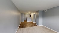 Located at 1012 33rd St SW in Birmingham, Alabama, this single-story 2-bedroom, 1-bathroom home offers a practical and cohesive layout designed for comfortable everyday living. Throughout the home, cool gray walls and crisp white trim create a clean, neutral palette that lends a consistent aesthetic to each room.

The combined kitchen and living area serves as the heart of the home, featuring wood-look flooring that extends through the main spaces. The kitchen is equipped with dark cabinetry, light countertops, a double-basin sink, and black appliances including a range and refrigerator, providing ample storage and functionality.

The living area transitions smoothly from the kitchen, with a mix of hard flooring and carpeted zones that define the space. A hallway connects the main living area to the bedrooms and bathroom, maintaining an efficient flow throughout.

The primary bedroom is generously sized, featuring plush carpeting, a ceiling fan with light fixture, a window with outdoor views, and a closet. The second bedroom also offers carpeted flooring and a window that brings in natural light, giving both rooms a comfortable and airy feel.

The bathroom includes a vanity with dark cabinetry and stone-topped counters, a tiled tub-shower combination, and wood-look flooring, completing the home with a clean and functional finish.