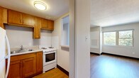 Located at 2727 Lancashire Rd in Cleveland Heights, OH, this two-bedroom, one-bathroom unit offers a practical and efficiently designed single-floor layout. Hardwood-style flooring runs consistently throughout the space, lending a warm, cohesive feel to every room.

The kitchen is thoughtfully equipped with warm wood cabinetry, ample upper and lower storage, a double-basin sink, an electric range, and a full-size refrigerator. A pass-through opening connects the kitchen to the rest of the unit, enhancing the sense of openness.

The primary bedroom is a comfortable retreat featuring a large wall of louvered bi-fold closet doors that provide generous storage. A single window frames lush, green tree canopy views, filling the room with natural light. The second bedroom is a clean, neutral space with its own door access and easy connectivity to adjacent rooms.

The bathroom is well-appointed with a single-sink vanity, a mirrored medicine cabinet, and a full tub-shower combination, all finished in a clean white palette with wood-style flooring.

Throughout the unit, neutral gray walls, dark baseboards, and textured ceilings create a simple, understated aesthetic. The overall layout is compact yet functional, making efficient use of every square foot available.