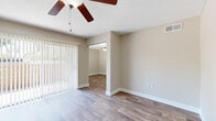 Located in Largo, FL, this single-story home offers a practical and comfortable layout across four bedrooms and two full bathrooms. The living room is bright and open, featuring wood-look laminate flooring, a ceiling fan, and vertical blinds that allow for natural light. It connects seamlessly to the adjoining dining or secondary living area, creating a cohesive flow throughout the common spaces.

The galley-style kitchen is well-appointed with warm honey-toned wood cabinetry, dark granite-look countertops, wood-look flooring, and white appliances including a range, refrigerator, and dishwasher. Ample upper and lower cabinet storage makes this kitchen highly functional.

The four bedrooms are finished with plush carpeting, neutral beige walls, and ceiling fans. Several rooms feature windows with blinds that bring in natural light. The primary bedroom includes access to a dedicated closet. The secondary bedrooms are generously sized and versatile.

Both bathrooms include tub-shower combinations with clean white surrounds and wood-look flooring, maintaining a consistent and easy-to-maintain aesthetic throughout. A hallway connects the bedroom wing to the rest of the home, and two closets provide additional storage. The overall palette of warm neutrals and durable finishes gives this home a clean, move-in ready appeal.