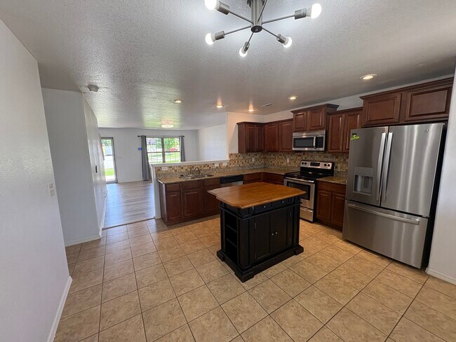 Kitchen and downstairs living area - 4208 SW Fieldstone Blvd