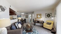 Located at 2006 Airline Rd in Corpus Christi, TX, this single-floor residence offers a thoughtfully designed layout that balances comfort and functionality. The open-concept living and dining area serves as the heart of the home, featuring plush carpeting, a wall-mounted TV, and a pass-through window that connects seamlessly to the kitchen, enhancing the sense of openness. The kitchen is outfitted with rich dark wood cabinetry, granite-style countertops, stainless steel appliances — including a refrigerator, range, and dishwasher — and wood-look flooring, creating a polished and practical cooking space. The adjacent dining area comfortably accommodates a table and chairs, accented by framed artwork that adds a refined touch. The primary bedroom is generously sized with soft carpeting, a ceiling fan, a walk-in closet, and a window that allows natural light to filter in. A second bedroom mirrors this comfortable aesthetic with carpeted floors, a ceiling fan, and a bright window. Both bathrooms feature dark vanity cabinetry, granite-style countertops, wood-look flooring, and shower-tub combinations. Throughout the unit, a neutral color palette and consistent design elements create a cohesive, inviting ambiance.