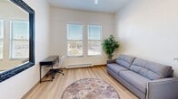 Located at 831 Front St in Santa Cruz, California, this efficiently designed studio unit offers a well-organized single-floor layout that maximizes every square foot. The main living area features light hardwood flooring, neutral white walls, and a pair of windows fitted with horizontal blinds that allow natural light to filter in while maintaining privacy. The space comfortably accommodates a sofa, desk, and area rug, making it functional as both a living and work area.

A compact kitchenette is seamlessly integrated into the unit, equipped with gray cabinetry, a countertop sink, a microwave, and a compact refrigerator — providing essential cooking and storage conveniences. A large decorative mirror is mounted on the adjacent wall, adding depth and brightness to the space.

The entryway features a smart lock on the front door and opens to a small foyer area with access to a closet, offering practical storage solutions. The full bathroom is clean and well-appointed, with a combination shower and bathtub, a toilet, a vanity, and light hardwood-style flooring. Decorative wall art and coordinated towel accents give the bathroom a warm, finished feel.

Overall, this unit presents a bright, clean, and efficiently arranged living space in the heart of Santa Cruz.