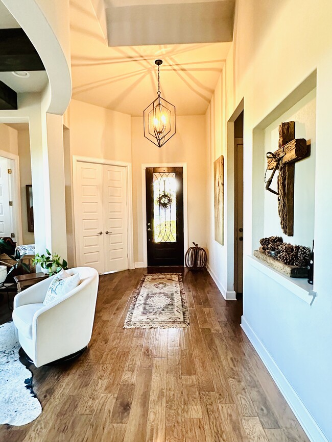 Foyer with powder room and office doors on left. Main garage doors on right - 429 Pink Granite Blvd