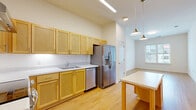 Located at 699 County Road 631 in Charlottesville, VA, this well-designed one-bedroom, one-bathroom residence offers a functional and modern living experience across a single floor. Light wood flooring flows seamlessly throughout, creating a warm and cohesive aesthetic in every room.

The open-concept layout combines the kitchen, dining area, and living room into one connected space, maximizing usability and promoting an airy feel. The kitchen is well-appointed with light maple cabinetry extending to the ceiling, white countertops, and a full suite of stainless steel appliances including a range, dishwasher, and French door refrigerator with ice maker. Pendant lighting above the dining area adds a polished touch.

The bedroom is a comfortable, well-proportioned room bathed in natural light from a window overlooking the surrounding neighborhood. Crisp white walls keep the space bright and versatile. Three closets throughout the unit provide generous storage options.

The bathroom features a single-sink vanity with matching maple cabinetry, a white countertop, and a large mirror, maintaining the clean, consistent design language found throughout the home. A dedicated laundry area adds everyday convenience. The overall ambiance is clean, modern, and move-in ready.