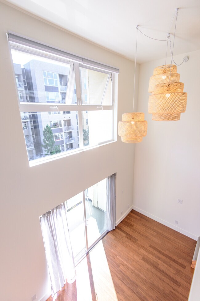 A bamboo pendant light chandelier highlights the 17' high ceiling in the loft - 2250 NW 58th St