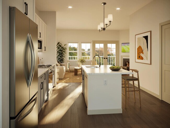 Cocina luminosa con isla con encimera de cuarzo, armarios de diseño minimalista y líneas visuales que conectan las zonas de cocina, comedor y sala de estar. - Modera Weston