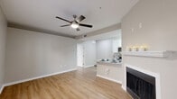 Located at 315 Valleywood Dr in Spring, TX, this two-bedroom, three-bathroom home offers a thoughtfully designed single-floor layout. The open-concept living and dining area is anchored by a classic fireplace and features warm wood-look flooring, neutral toned walls, and a ceiling fan that enhances the comfortable ambiance. Natural light flows in through blinds-fitted windows, adding brightness throughout.

The kitchen is efficiently designed in a galley style, showcasing granite countertops, crisp white cabinetry with modern hardware, stainless steel appliances including a refrigerator and dishwasher, and a breakfast bar that connects to the living space. A washer and dryer unit is conveniently tucked within the kitchen area.

The entryway welcomes residents with built-in shelving and additional window light. Both bedrooms are carpeted and include ceiling fans, with the primary bedroom offering a walk-in closet with wire rack shelving and direct access to a private bathroom. A hallway leads to a vanity area with granite counters and white cabinetry. Bathrooms are finished with wood-look flooring and tub-shower combinations. Two closets provide ample storage throughout the home.