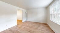 Located at 80 Sandune Dr in Pittsburgh, PA, this 2-bedroom, 1-bathroom home spans three floors, offering a well-organized and functional layout throughout. The entry level welcomes you with light wood-style flooring, neutral white walls, and a staircase leading to the upper levels, creating a bright and open first impression. The galley-style kitchen is efficiently designed with warm honey-toned wood cabinetry, dark granite countertops, a full suite of white appliances including a range, dishwasher, refrigerator, and over-the-range microwave, plus a window that brings in natural light. Adjacent to the kitchen is a secondary area with matching cabinetry and countertops, ideal for additional storage or prep space. The full bathroom features a tub-shower combination, wood-style flooring, and a small window for ventilation and natural light. Both bedrooms are carpeted for comfort, each with windows fitted with blinds and closets with double panel doors, providing ample storage. The primary bedroom is generously sized with a built-in closet. The lower level hosts a spacious utility room with exposed structural elements, housing the HVAC system and laundry hookups, offering practical additional storage and utility space.