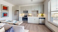 This 520 square foot apartment in Farmers Branch, Texas, exemplifies efficient modern living. The space is thoughtfully designed with a single floor plan that maximizes functionality. The primary bedroom, measuring 130 square feet, serves as a comfortable retreat with high ceilings that create an airy atmosphere. It features a stylish upholstered headboard, ample natural light, and convenient built-in closet space.

The kitchen is a standout feature, boasting sleek white cabinetry, stainless steel appliances, and a striking geometric backsplash. Under-cabinet lighting enhances the workspace, while a window provides natural light and outdoor views. The layout includes a full suite of appliances, including a refrigerator, stove, microwave, and dishwasher, making it fully equipped for culinary pursuits.

Throughout the apartment, neutral tones dominate, creating a bright and open feel. The use of light wood-look flooring adds warmth and continuity. Thoughtful touches like modern light fixtures, contemporary artwork, and strategically placed mirrors enhance the overall aesthetic. Despite its compact size, the apartment doesn't compromise on style or functionality, offering a harmonious blend of comfort and contemporary design in an urban setting.