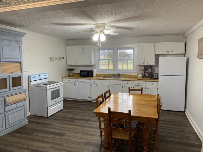 Kitchen with new stove and refrigerator. - 4250 Louis Draughon Rd