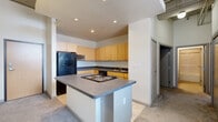 Located on Euclid Avenue in the heart of Cleveland, this 2-bedroom, 2-bathroom unit offers a distinctive loft-inspired aesthetic with industrial design elements throughout. Exposed ductwork and concrete ceiling details add character to the open-concept living, dining, and kitchen area, which is bathed in natural light and features plush carpeting flowing through the expansive common space.

The kitchen is well-equipped with light maple cabinetry, dark stone-look countertops, a central island with a built-in cooktop, a double sink, dishwasher, refrigerator, and built-in microwave — providing ample prep and storage space. Tile flooring anchors the kitchen zone, transitioning seamlessly into the carpeted living and dining areas.

Both bedrooms are generously proportioned, with soft carpeting and windows that bring in natural light. The primary bedroom offers a comfortable retreat with access to one of the two full bathrooms. Each bathroom includes a tub/shower combination and tile flooring, with one featuring a warm wood-toned vanity with stone countertop.

Additional highlights include three closets for plentiful storage, a dedicated laundry area, and a private balcony. The unit's loft-style architecture and urban Euclid Avenue address make it a compelling option in downtown Cleveland.