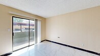 Located at 7111 N 75th Ave in Glendale, Arizona, this well-appointed one-bedroom, one-bathroom unit offers an efficient and comfortable layout across a single floor. The living area features gleaming marble-look tile flooring, warm neutral-toned walls, and a textured ceiling, with a sliding glass door that opens to a private patio and allows natural light to fill the space.

The kitchen is thoughtfully designed with white shaker cabinetry, dark granite countertops, and a full suite of stainless steel appliances including a refrigerator, range, and microwave. A double-basin sink and a peninsula with additional counter space enhance both functionality and flow.

The bedroom is a comfortable retreat with warm hardwood flooring, a window that brings in natural light, and a wall-mounted HVAC unit for personalized climate control. A dedicated walk-in closet with dual hanging rods and shelving on both sides provides generous storage capacity.

The bathroom features a clean, full-size soaking tub and shower combo with chrome fixtures and built-in wall niches, finished in bright white for a fresh, clean aesthetic. Throughout the unit, the combination of hardwood floors, marble-look tile, and updated finishes creates a cohesive and inviting atmosphere suited for comfortable everyday living.