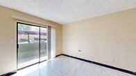 Located at 7111 N 75th Ave in Glendale, Arizona, this well-appointed one-bedroom, one-bathroom unit offers an efficient and comfortable layout across a single floor. The living area features gleaming marble-look tile flooring, warm neutral-toned walls, and a textured ceiling, with a sliding glass door that opens to a private patio and allows natural light to fill the space.

The kitchen is thoughtfully designed with white shaker cabinetry, dark granite countertops, and a full suite of stainless steel appliances including a refrigerator, range, and microwave. A double-basin sink and a peninsula with additional counter space enhance both functionality and flow.

The bedroom is a comfortable retreat with warm hardwood flooring, a window that brings in natural light, and a wall-mounted HVAC unit for personalized climate control. A dedicated walk-in closet with dual hanging rods and shelving on both sides provides generous storage capacity.

The bathroom features a clean, full-size soaking tub and shower combo with chrome fixtures and built-in wall niches, finished in bright white for a fresh, clean aesthetic. Throughout the unit, the combination of hardwood floors, marble-look tile, and updated finishes creates a cohesive and inviting atmosphere suited for comfortable everyday living.