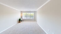 Located at 1100 Pulaski St in Columbia, SC, this 2-bedroom, 2-bathroom residence offers a thoughtfully designed single-floor layout with a clean, modern aesthetic throughout. The open kitchen and living area serve as the heart of the home, where the kitchen showcases granite countertops, white cabinetry with brushed nickel hardware, a classic subway tile backsplash, and a full suite of stainless steel appliances. A peninsula with pendant lighting connects seamlessly to the dining area, accented by crown molding and light hardwood-style flooring. The spacious living room is bathed in natural light from large windows and features plush carpeting and textured ceilings with crown molding details. Both bedrooms offer comfortable proportions with soft carpet underfoot and ample natural light. The primary bedroom includes a mirrored sliding-door closet, providing generous storage. Each bathroom is finished with granite-topped white vanities, brushed nickel fixtures, and hardwood-style flooring, with one bathroom offering a full tub/shower combination. A dedicated in-unit laundry area with wire shelving adds everyday convenience to this well-appointed residence.