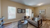 Located at 12 Wilkinson Way in Bluffton, SC, this single-floor residence offers a thoughtfully designed layout with modern finishes throughout. The open-concept kitchen is a standout feature, showcasing rich dark cabinetry, granite countertops, stainless steel appliances including a range, microwave, and refrigerator, under-cabinet lighting, and a peninsula island with pendant lighting — ideal for both cooking and casual dining.

The living area is bathed in natural light from multiple windows, creating a warm and inviting atmosphere. Neutral-toned walls and wood-style flooring flow seamlessly throughout the space, lending a cohesive and contemporary aesthetic.

The bedroom features vaulted ceilings, a ceiling fan, generous windows, wood-style flooring, and access to a walk-in closet, offering both comfort and practicality. The bathroom is cleanly appointed with tile-surround tub and shower, wood-style flooring, and dark vanity cabinetry with ample storage.

A dedicated laundry room includes a full-size washer and dryer, adding everyday convenience. The overall design balances functionality with understated elegance, making this Bluffton residence a well-rounded and livable space.