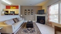 This single-floor residence offers a thoughtfully designed layout that balances comfort and functionality across its key living spaces. The living room serves as the heart of the home, anchored by a classic fireplace and finished with plush carpeting and neutral-toned walls. An open pass-through connects seamlessly to the kitchen, which is equipped with stainless steel appliances, light maple cabinetry, tile flooring, and ample counter space — making it both practical and visually appealing. Adjacent to the living area, a dedicated dining space provides an intimate setting for everyday meals or entertaining.

The two bedrooms are carpeted and filled with natural light. The primary bedroom features French doors that open to the outside, a walk-in closet, and generous proportions. The second bedroom also includes a closet with built-in shelving, offering useful storage.

Two full bathrooms serve the residence. One includes a soaking tub and shower combination with a decorative curtain, light maple vanity, and tile flooring. The second bathroom mirrors a similar aesthetic with a large mirror, clean white countertop, and neutral tile. Together, the spaces create a cohesive, warm, and functional home environment.