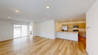 Located at 3782 Thunderhawk Pass in Fort Wayne, Indiana, this single-story home offers a well-designed layout with 3 bedrooms, 2 bathrooms, and a thoughtful mix of functional spaces. Light-toned hardwood flooring flows consistently throughout, creating a bright and cohesive aesthetic across all rooms.

The heart of the home is an open-concept living, dining, and kitchen area. The kitchen stands out with gray shaker-style cabinetry, light quartz countertops, a peninsula with a sink, and stainless steel appliances including a gas range, built-in microwave, and a French door refrigerator with water dispenser. Recessed lighting illuminates the space efficiently.

The spacious primary bedroom features recessed lighting and direct access to its own bathroom, which includes a glass-enclosed shower, white vanity, and clean, modern finishes. The two additional bedrooms are well-proportioned with natural light from large windows with blinds. The home includes an impressive seven closets, offering exceptional storage throughout.

A dedicated laundry room comes equipped with a full-size Maytag washer and dryer. The attached garage provides additional storage and parking. A pantry adds kitchen convenience, and a patio extends the living space outdoors. The overall ambiance is clean, modern, and move-in ready.