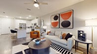 This single-story residence located in Bradenton, Florida offers a thoughtfully designed open-concept layout finished with contemporary details throughout. The kitchen serves as a central highlight, featuring crisp white cabinetry extending to the ceiling, stainless steel appliances including a French door refrigerator, electric range, microwave, and dishwasher, paired with light granite countertops and a tile backsplash. A large central island with pendant lighting above provides seating and additional prep space, flowing seamlessly into the dining and living areas. The living room is bright and welcoming, with wood-style plank flooring, a ceiling fan, and a glass-paneled door that invites natural light and outdoor access. The bedrooms are comfortably proportioned, each featuring ceiling fans, large windows with views of greenery, and wood-style flooring that continues throughout the unit. The bathroom is cleanly designed with a glass-enclosed walk-in shower, white vanity cabinetry, and a large mirror framed by bright lighting. Recessed lighting, neutral wall tones, and consistent flooring tie each area together, creating a cohesive and modern aesthetic suited for everyday living in the Bradenton area.
