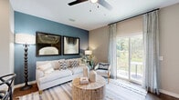 Located at 1851 Encantado Way in Kissimmee, Florida, this two-story home offers a thoughtfully designed layout spread across two floors of comfortable living space. The main level features a bright living room with a ceiling fan, a bold accent wall, and sliding glass doors that open to a private patio with lush outdoor views. The kitchen is outfitted with white shaker cabinetry, granite countertops, stainless steel appliances, and a dedicated pantry. A separate office with carpet flooring and a teal accent wall provides a quiet workspace, while an in-unit laundry area adds everyday convenience. A carpeted staircase with white railings leads to the upper floor, where two bedrooms and two full bathrooms are located. The primary bedroom includes its own walk-in closet and direct bathroom access. The secondary bedroom features plush carpet, natural light from a window, and an adjacent full bath with a soaking tub and granite vanity. Each bathroom is finished with tile flooring, white cabinetry, and granite countertops—one with a glass-enclosed walk-in shower. Three closets throughout the home ensure generous storage, and neutral warm-toned walls create a cohesive, inviting ambiance throughout.