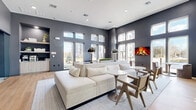 Located at 72 Eagle Rock Ave in East Hanover, NJ, this single-floor lounge space offers a sophisticated and contemporary design that makes a strong architectural statement. The living area is anchored by soaring ceilings and floor-to-ceiling windows that flood the interior with natural light, offering views of the surrounding community. Deep charcoal-gray walls create a bold contrast against the light-toned hardwood flooring, lending the space a refined, modern aesthetic throughout.

The main living area is thoughtfully arranged with a generous sectional sofa, sleek pedestal side tables, and contemporary accent chairs positioned around a centrally placed area rug. A wall-mounted electric fireplace adds warmth and visual interest to one end of the room, while stylish dome pendant lamps and wall sconces provide layered lighting.

A built-in nook along one wall houses a coffee station with cabinetry and open display shelving above, adding both functionality and decorative appeal. Glass-paneled partition walls and dark-framed sliding doors separate an adjacent workspace or conference area, maintaining visual connectivity while defining distinct zones within the open floor plan.

The overall ambiance is clean, airy, and upscale, blending comfort with professional-grade design — making this a highly versatile and welcoming communal environment.