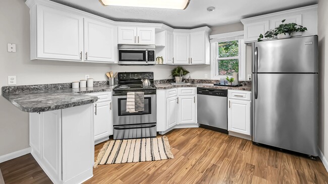 Elegant stainless steel appliances add modern style to our charming kitchens at The Willows. - The Willows