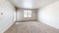 This well-designed 730 square foot apartment in West Fargo offers a blend of comfort and functionality. The heart of the home is the modern kitchen, boasting rich wood cabinetry, sleek black appliances, and expansive granite countertops that extend to a convenient breakfast bar. The open-concept layout seamlessly connects the kitchen to the living area, which is carpeted for comfort and features large windows that flood the space with natural light.

The bedroom, measuring 140 square feet, provides a cozy retreat with plush carpeting and a sizeable window. The bathroom continues the apartment's contemporary feel with a granite-topped vanity matching the kitchen's aesthetic. A notable feature is the in-unit laundry area, equipped with full-sized washer and dryer, adding considerable convenience to daily life.

Storage is ample throughout, with a dedicated closet space and additional cabinetry in the kitchen. The apartment's neutral color palette of whites and beiges creates a blank canvas for personal decorating styles. Baseboard heating ensures comfort year-round, while the large windows offer the potential for cross-ventilation during warmer months. This thoughtfully designed space maximizes every square foot, creating an efficient and inviting home environment.