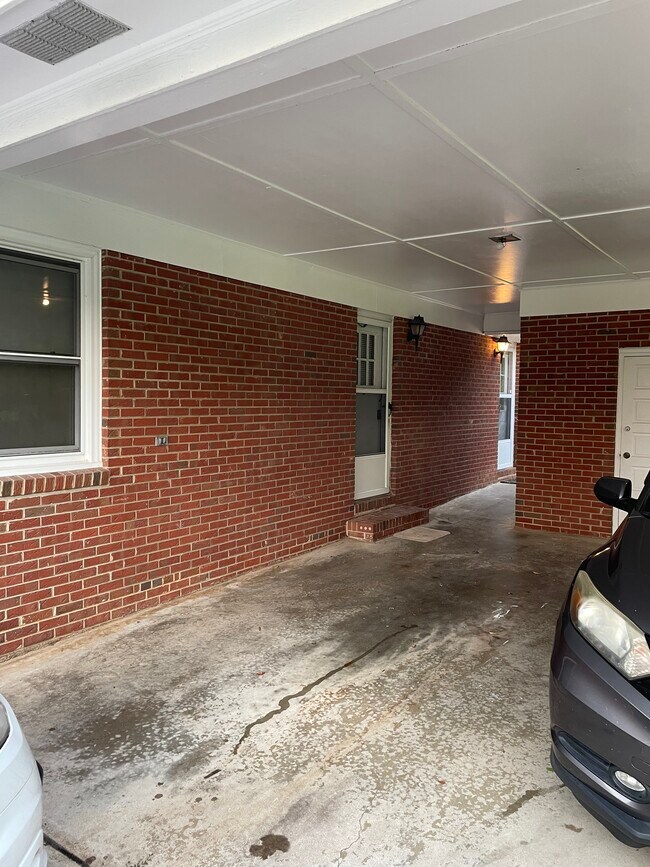 Covered porch and covered parking. - 423 Melody Ln