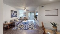Located at 1720 John West Rd in Dallas, TX, this single-floor residence offers a thoughtfully designed layout with consistent wood-style flooring throughout and a neutral color palette that creates a warm, cohesive atmosphere.

The living area is generously sized, anchored by a ceiling fan and sliding glass doors that open to a private outdoor patio, filling the space with natural light and providing easy outdoor access. The open layout connects seamlessly to a dining area, making it well-suited for both relaxing and entertaining.

The kitchen is efficiently designed with gray shaker-style cabinetry, light granite-look countertops, and black appliances including a range, refrigerator, and over-the-range microwave. A window above the sink allows for natural light, enhancing the functionality of the workspace.

The bedroom is a comfortable retreat featuring a ceiling fan with light fixture, large windows that invite ample natural light, and sliding glass door access to a private patio. The textured ceiling adds a classic touch consistent throughout the home.

The bathroom is clean and functional, finished with tile surrounds and a curved shower curtain rod over the tub-shower combination, offering a practical and well-maintained space.

Overall, this residence combines practical design with comfortable living in a convenient Dallas location.