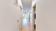 Located on the third floor at 4603 Minnehaha Ave in Minneapolis, Minnesota, this thoughtfully designed unit offers a clean, modern aesthetic across a single-floor layout. Light-toned hardwood flooring runs throughout, lending warmth and visual continuity to the space.

The open living and kitchen area serves as the heart of the unit. The kitchen is outfitted with white flat-panel cabinetry, warm natural wood open shelving, a subway tile backsplash, gray quartz-style countertops, and a full suite of stainless steel appliances including a refrigerator, electric range, microwave, and dishwasher. Recessed lighting and windows allowing natural light keep the space feeling bright and airy.

A corridor connects the main living area to the private rooms, with convenient in-unit stacked laundry tucked just off the hallway. The bathroom features a full tub and shower combination with a curved curtain rod, clean white finishes, and light hardwood-style flooring consistent with the rest of the unit.

The living area is open and versatile, with crisp white walls, recessed lighting, and a window that brings in natural light. The overall design is minimal and contemporary, making efficient use of the available footprint while maintaining a comfortable and functional living environment.
