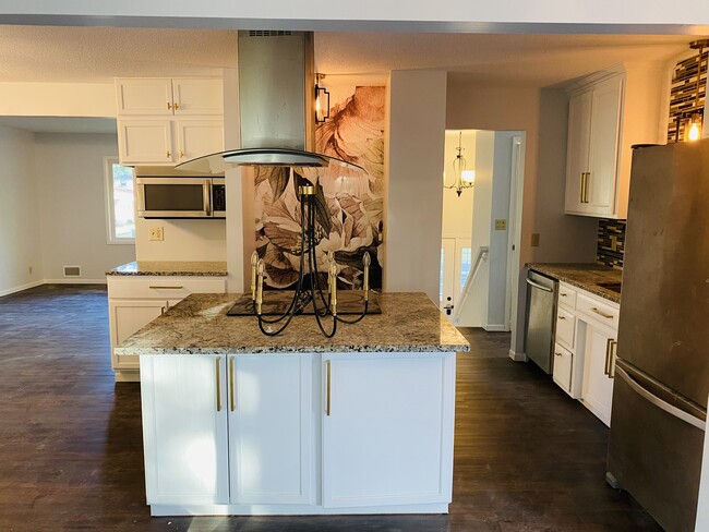 Family room flowing into an open kitchen and Formal Living Room in the back. - 4219 Boone Ave N
