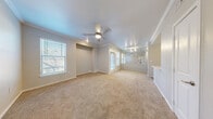 Located at 6010 S Westmoreland Rd in Dallas, Texas, this single-story, one-bedroom, one-bathroom home offers a well-organized layout across a comfortable footprint. The open-concept living and dining area is a standout feature, finished with plush wall-to-wall carpeting, crown molding, and a ceiling fan. Multiple windows with slatted blinds allow generous natural light to flow through the space, while a large mirror enhances the sense of openness. The galley-style kitchen is thoughtfully designed with white cabinetry, white tile backsplash, light wood-look flooring, and a full suite of stainless steel appliances including a range, microwave, dishwasher, and refrigerator. A dedicated pantry provides additional storage. The bedroom is carpeted and well-sized, featuring two closets, a ceiling fan, and windows with outdoor views. Crown molding adds a refined touch. The bathroom includes a full tub-shower combination with tile surround, a vanity with granite-style countertop, and wood-look flooring. Additional functional spaces include a hallway and a dedicated laundry area, rounding out this practical and neatly appointed single-story home.