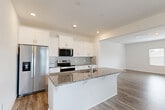 Located at 216 Meyers Ridge Rd in Cramerton, NC, this two-story home offers a thoughtfully designed layout across two well-proportioned floors. The main level features an open-concept living, dining, and kitchen area anchored by rich hardwood-style flooring throughout. The kitchen is a standout, boasting white shaker cabinetry, granite countertops, a center island with a built-in sink, subway tile backsplash, and stainless steel appliances including a refrigerator, range, microwave, and dishwasher. The living area is bright and airy, with large windows and a patio door allowing natural light to fill the space. Two patios provide outdoor access for relaxing or entertaining. Upstairs, four well-sized bedrooms feature plush carpeting and ample closet space, with the generously sized primary bedroom offering a comfortable retreat. The dedicated laundry room on the upper floor includes a full-size washer and dryer hookups and a bright window. Three full bathrooms are distributed throughout the home, including one with a glass-enclosed walk-in shower and tile flooring. A utility room and six closets round out the functional storage options in this clean, move-in-ready home.