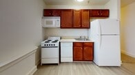 Located at 415 W Grace St in Richmond, Virginia's vibrant Grace Street corridor, this single-floor unit offers a practical and well-organized layout suited for everyday living. The interior is arranged along a central carpeted hallway, lined with clean white walls, white trim, and overhead flush-mount lighting that guides you through the space.

The bedrooms feature neutral wall-to-wall carpeting, generous closet space with built-in shelving and hanging rods, and windows with blinds that bring in natural light and street views. Ceiling heights feel elevated, contributing to an open and airy atmosphere throughout.

A separate room with light gray wood-look flooring and a large window offers flexibility as a living area, home office, or additional bedroom, providing views of the surrounding neighborhood.

The unit includes two full bathrooms, each equipped with a single-sink vanity featuring rich wood cabinetry and a white countertop, a toilet, and a tub-shower combination. One bathroom features tile flooring with a large mirror above the vanity, while the other offers a similar functional layout with clean, bright finishes.

The 3D floorplan reveals an elongated layout with distinct zones for living, sleeping, and bathing, making efficient use of the available footprint. Overall, the unit presents a clean, move-in ready environment in a well-situated Richmond location.