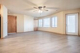 Located at 769 North Star Drive in Madison, WI, this one-bedroom, one-bathroom unit offers a well-organized single-floor layout with consistent light hardwood-style flooring and warm neutral tones throughout. The living room serves as the central gathering space, highlighted by a tile-surround fireplace and a ceiling fan with integrated lighting. Large windows fitted with blinds allow natural light to fill the room, creating a bright and welcoming atmosphere. The galley-style kitchen is efficiently designed with light wood cabinetry, laminate countertops, a double-basin sink, a dishwasher, and stainless steel appliances including a refrigerator and range. Overhead flush-mount lighting ensures the kitchen remains well-lit. The generously sized primary bedroom features dual windows that bring in ample natural light and includes a double-door closet for storage. The full bathroom is cleanly appointed with a tub-shower combination, a toilet, and wood-toned doors. A dedicated hallway and closet contribute to the unit's practical flow. Warm-toned baseboards with wood accents frame each room, adding a cohesive finishing detail throughout the space.
