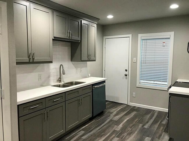 Kitchen sink and dishwasher - all units have access to rear parking area, note the 2" faux wood blinds! - 5005 Tierwester st
