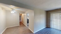 Located at 953 Hunt Ave NW in Roanoke, Virginia, this single-floor residence offers a thoughtfully laid-out interior with a clean, updated aesthetic throughout. The living area features dark wood-look flooring and a sliding glass door dressed with vertical blinds, allowing natural light to filter in while providing access to the outdoors. A ceiling fan adds both function and character to the space.

The galley-style kitchen is well-appointed with crisp white cabinetry, marble-look countertops, and a full suite of stainless steel appliances, including a refrigerator, range, dishwasher, and range hood. Wood-look flooring continues seamlessly through this space, lending a cohesive feel.

The bedrooms are carpeted for comfort and feature neutral walls, generous closet space — including a double bi-fold closet in one room — and windows with blinds that bring in natural light. The layout connects the living areas through a hallway, creating a logical and practical flow throughout the home.

The bathroom is finished with a tub/shower combination, a single-sink vanity with brushed nickel fixtures, a wide mirror, and warm overhead lighting. Neutral tones across all rooms create a calm, versatile backdrop ready for personalization.