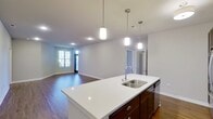 Embrace a life of elegance and comfort in this exquisite 3-bedroom, 2-bathroom apartment at the coveted Arrabelle Apartments in Cedarburg. With 990 square feet of thoughtfully designed space, this home seamlessly blends contemporary style with practical living.

Step into a world of luxury as you're greeted by stunning wood floors that flow throughout the main living areas, creating a warm and inviting atmosphere. The open-concept kitchen and living room are a testament to modern design, featuring a spacious island perfect for casual dining and entertaining. The kitchen boasts sleek stainless steel appliances, rich dark wood cabinetry, and gleaming countertops, inspiring your inner chef.

Large windows in every room bathe the space in natural light, while offering picturesque views of the surrounding area. The primary bedroom, a generous 190 square feet, provides a serene retreat with plush carpeting and ample closet space. Two additional bedrooms offer versatility for a home office, guest room, or children's quarters.

Both bathrooms showcase a blend of style and function with elegant fixtures, spacious vanities, and a combination of wood-look and tile flooring. The attention to detail is evident in every corner, from the modern lighting fixtures to the crisp white walls that serve as a blank canvas for your personal style.

This apartment isn't just a place to live; it's a lifestyle choice. Located in the heart of Cedarburg, you'll have easy access to local amenities, dining, and entertainment. Whether you're a young professional, a growing family, or someone looking to downsize without compromising on quality, this home offers the perfect balance of comfort, style, and location. Make your move to elevated living at Arrabelle Apartments today.