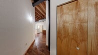 Located in the heart of Milwaukee's downtown at 249 N Water St, this two-bedroom, one-bathroom loft masterfully blends historic industrial character with modern comfort. The open living area commands attention with soaring exposed timber beam ceilings, warm hardwood floors, and original brick walls that tell the story of the building's storied past. Oversized wood-framed windows flood the space with natural light and frame striking views of the Milwaukee skyline and surrounding cityscape, while a private balcony extends the living space outdoors.

The kitchen is thoughtfully appointed with granite countertops, a breakfast bar, light maple cabinetry, tile flooring, and exposed ductwork that nods to the loft's industrial roots. The beamed ceiling continues seamlessly throughout, reinforcing the open, airy feel of the space.

The primary bedroom is generously sized and features large windows with the same iconic city views, exposed brick, and plush carpeting. The second bedroom offers comfortable proportions, carpeted flooring, and a sliding wood closet. The full bathroom is clean and functional, finished with tile flooring, a tub-shower combination, and maple vanity cabinetry. Track lighting throughout adds a modern, gallery-like touch to this distinctive urban retreat.