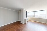 Located in the heart of Midtown Atlanta, this three-bedroom, two-bathroom residence offers a well-designed single-floor layout with a thoughtful mix of finishes and city views throughout. The combined kitchen and living area serves as the heart of the home, featuring rich hardwood flooring and elegant crown molding. Floor-to-ceiling corner windows flood the living space with natural light while framing sweeping views of the Atlanta skyline and surrounding cityscape.

The kitchen is efficiently appointed with white shaker cabinetry, dark granite countertops, a subway tile backsplash, and stainless steel appliances including a range, dishwasher, and refrigerator. The primary bedroom is generously sized, also benefiting from hardwood floors and large windows that invite abundant natural light. The two additional bedrooms feature plush carpeting and corner windows with their own city views, offering comfortable and versatile spaces.

The bathrooms are finished with dark granite vanity tops and large-format stone-look tile surrounding the soaking tubs, lending a clean, modern aesthetic. Throughout, the neutral gray palette and consistent finishes create a cohesive and contemporary ambiance well-suited to urban living in one of Atlanta's most vibrant neighborhoods.