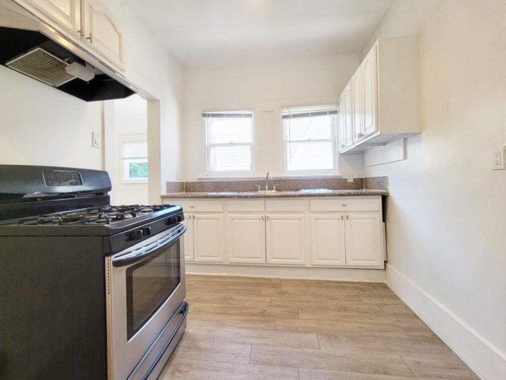 Kitchen with Stainless Steel Stove - 433 W 4th St