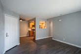 Located at 3983 Pierce St in Riverside, California, this single-floor unit offers a thoughtfully updated interior with a clean, contemporary aesthetic throughout. The open living area is finished with durable wood-look flooring and soft gray walls, creating a neutral and welcoming atmosphere. A ceiling fan provides added comfort, while a sliding glass door with vertical blinds fills the space with natural light and offers direct outdoor access.

The kitchen is efficiently designed in a galley layout, featuring warm-toned wood cabinetry, white quartz countertops, and a full suite of stainless steel appliances including an electric range, built-in microwave, and refrigerator. A deep single-basin sink with a matte black faucet adds a modern touch, and recessed lighting illuminates the workspace. A pass-through window connects the kitchen to the living area, enhancing the sense of openness.

The bedroom is generously sized, benefiting from multiple windows with horizontal blinds that allow ample natural light and outdoor views. A ceiling fan with a light fixture serves the room well.

The bathroom features a wide vanity with a quartz countertop, warm wood cabinetry with matte black hardware, a large mirror, and a full tub-shower combination. Wood-look flooring continues here, tying together the cohesive design of the entire unit.