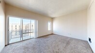 Located at 630 Wabash Avenue in Terre Haute, Indiana, this one-bedroom, one-bathroom unit offers a well-organized single-floor layout designed for comfortable everyday living. The living room is a bright, carpeted space highlighted by a sliding glass door that opens to a private balcony, offering open views of the surrounding cityscape and filling the room with abundant natural light. An adjacent dining area flows seamlessly from the living space, creating a cohesive area suited for both relaxing and entertaining. The kitchen features cabinetry with warm wood tones, a countertop workspace, and a sink, providing a functional and efficient cooking environment. The bedroom is a comfortably sized, carpeted retreat with a dedicated closet and a window that brings in additional natural light. A second closet elsewhere in the unit offers extra storage capacity. The full bathroom is finished with warm-toned stone-style tile flooring and includes a combined tub and shower, a toilet, and a vanity with cabinet storage. Throughout the unit, neutral wall tones and consistent carpeting create a clean, cohesive aesthetic. A hallway connects the key areas of the home, and the overall layout makes efficient use of the available space.