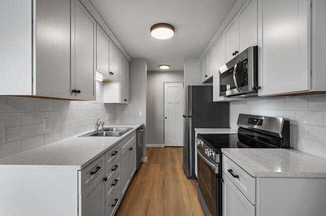 Cocina nueva con electrodomésticos de acero inoxidable y encimeras de piedra. - 1551 Namekagon St
