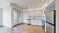 Located at 18900 Parthenia St in the Northridge neighborhood of Los Angeles, this thoughtfully designed one-bedroom, one-bathroom residence offers a clean, modern aesthetic throughout its efficiently utilized single floor. Light wood flooring flows seamlessly through every room, creating a warm and cohesive atmosphere.

The kitchen is a standout feature, equipped with stainless steel appliances — including a range, microwave, dishwasher, and refrigerator — complemented by white cabinetry, granite countertops, and a classic subway tile backsplash. Recessed lighting and an adjacent door providing access to a balcony area make the space feel open and well-connected.

The living area extends naturally from the kitchen, bathed in natural light and offering a clean, minimalist canvas. The bedroom is comfortably sized, featuring a large sliding-door closet and a generously sized window with treetop views, filling the room with abundant daylight.

The bathroom is finished with marble-style tile surrounds in the shower-tub combo, coordinating tile flooring, and a granite-topped vanity, maintaining the upscale, contemporary finishes found throughout the unit.

A hallway connects the rooms efficiently, completing this well-planned layout ideal for those seeking modern urban living in Los Angeles.