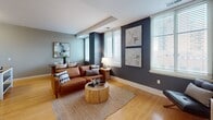 This 590 square foot apartment in Omaha, Nebraska offers a thoughtfully designed living space that maximizes functionality and style. The open-concept layout seamlessly integrates the living room, dining area, and kitchen, creating a spacious feel despite the compact footprint. The living area features a comfortable leather sofa, modern accent chairs, and a sleek entertainment center, all complemented by warm hardwood flooring and large windows that flood the space with natural light.

The kitchen boasts white cabinetry, stainless steel appliances, and a convenient center island, perfect for meal preparation or casual dining. The bedroom, measuring 110 square feet, provides a cozy retreat with plush carpeting and ample closet space. The bathroom is efficiently designed with a single vanity and a shower/tub combination.

Throughout the apartment, a neutral color palette is punctuated by bold accent walls and contemporary artwork, creating visual interest and depth. Stylish lighting fixtures and carefully curated decor elements add a touch of sophistication to the space. The overall design strikes a balance between modern aesthetics and practical living, making it an ideal home for urban professionals or small families seeking a well-appointed living space in the heart of Omaha.